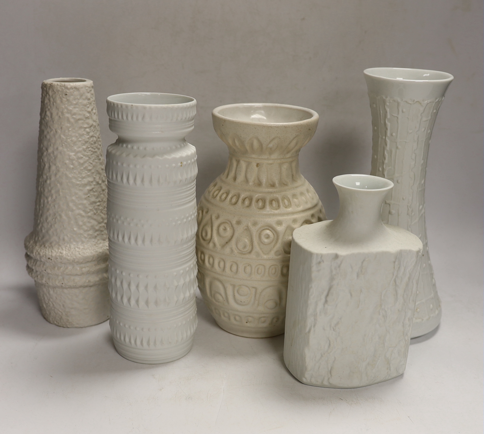 Five West German pottery and biscuit porcelain vases, tallest 24cm